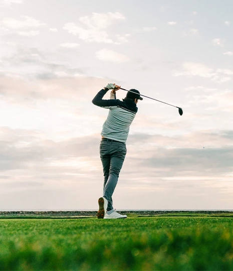 a man swinging a golf club