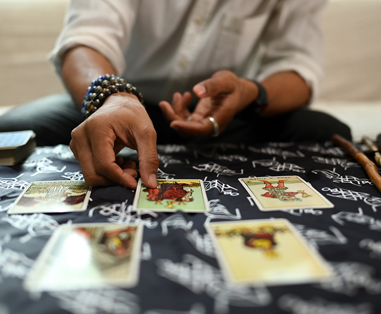 a person sitting on a table with cards
