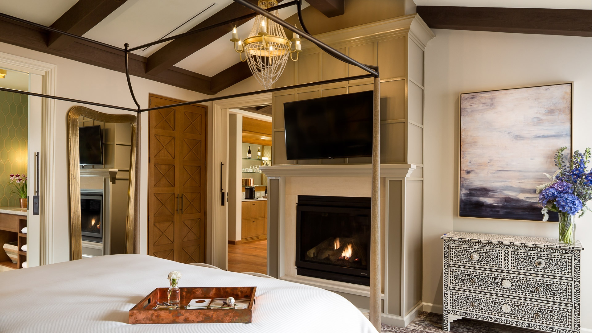 a bed with a fireplace in the background
