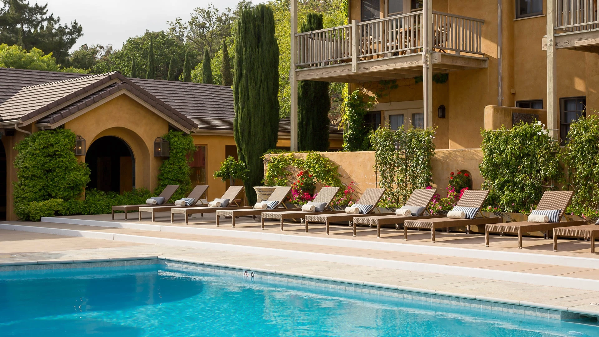 a pool with lounge chairs and a deck