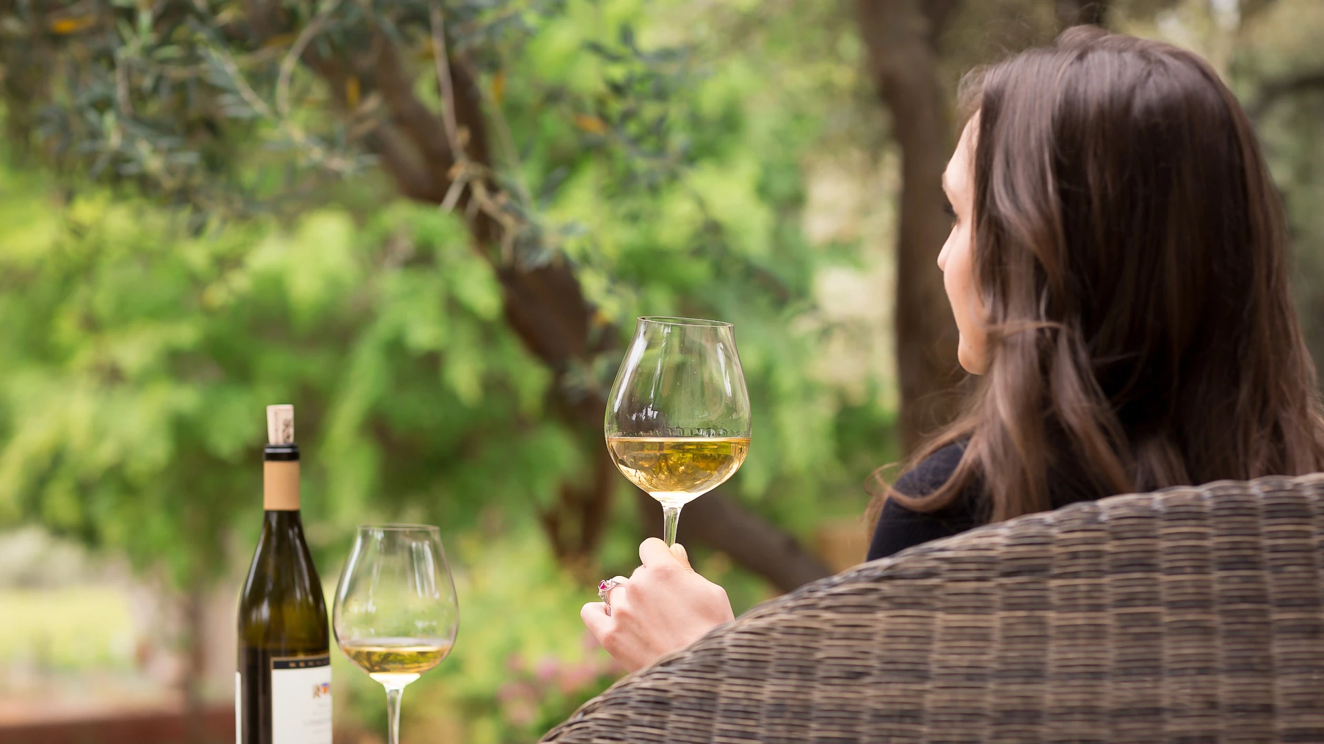 a woman holding a glass of wine