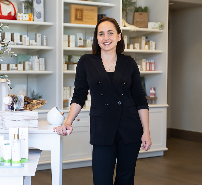 a woman standing in front of a white table