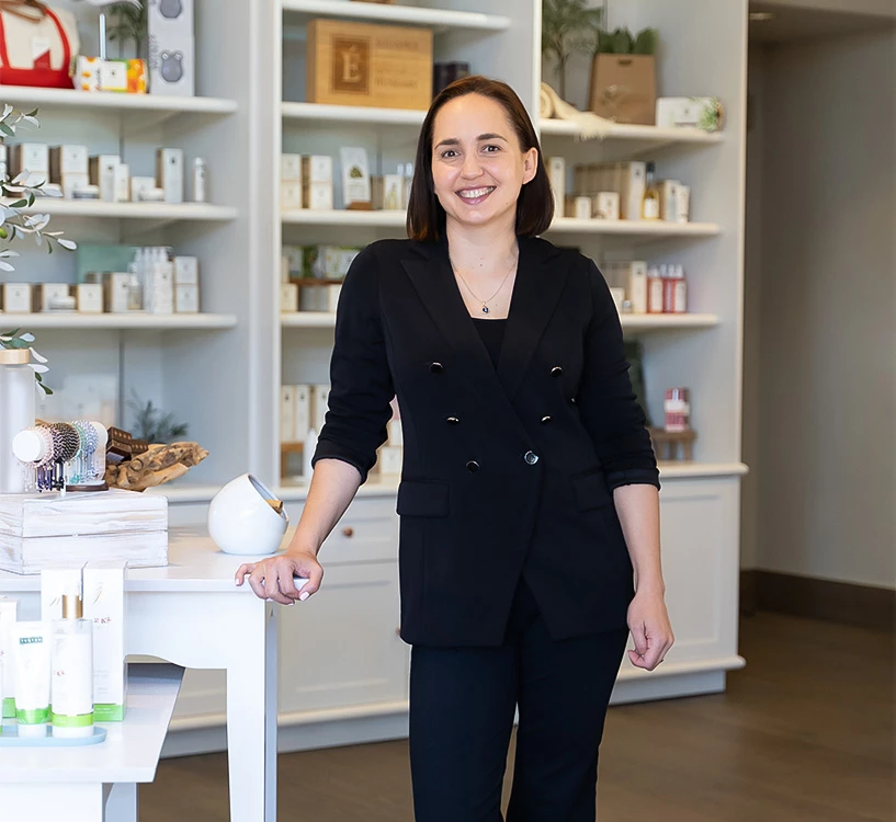 a woman standing in front of a white table