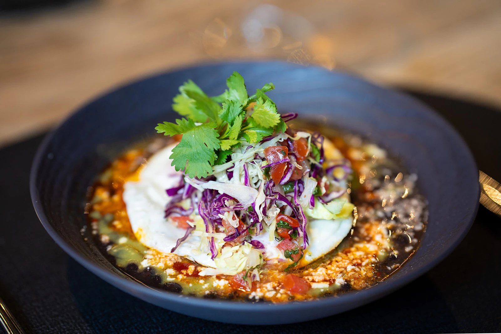 a plate of food with a white egg and vegetables