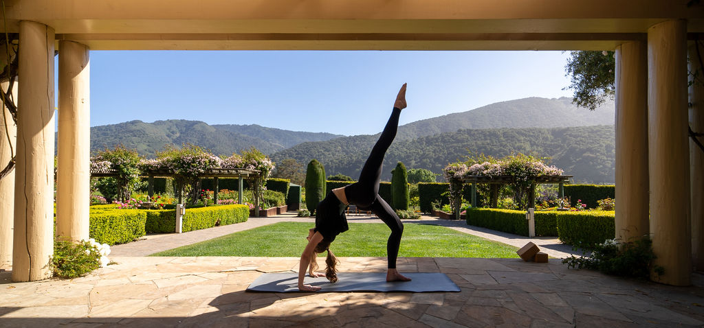 a woman doing yoga outside