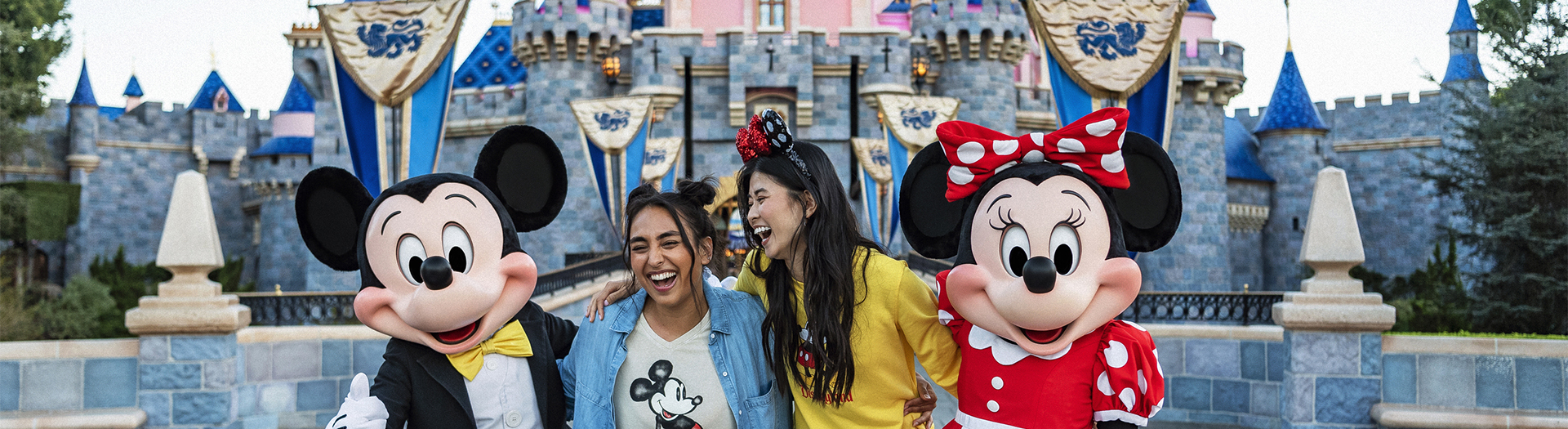 a group of women smiling with mickey mouse characters