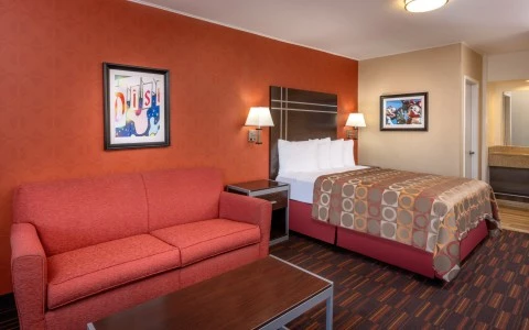 interior of hotel room with queen bed and sofa bed 