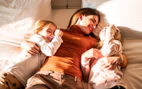 two children in bed with mom 