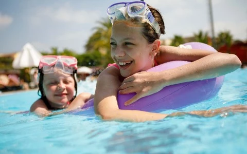 two young girls playing in the pool