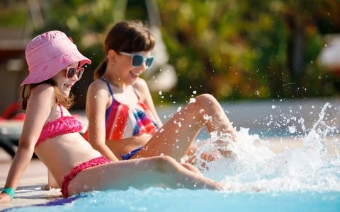 mother and daughter playing by the pool
