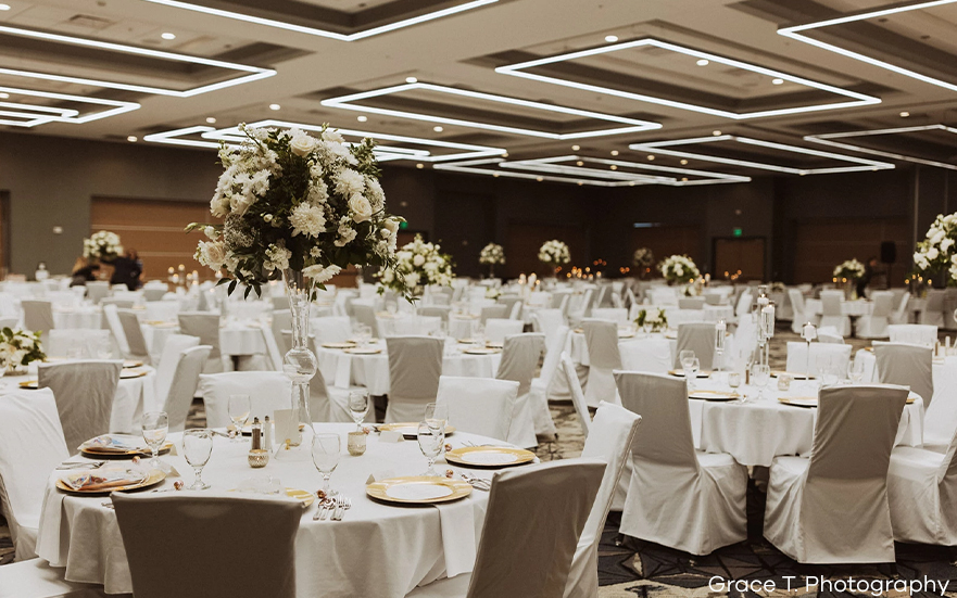 a large room with tables set for a wedding