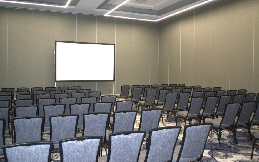 a room with chairs and a projector screen