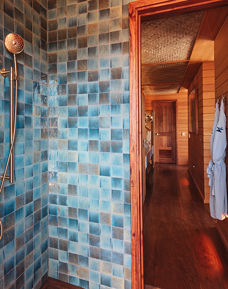 a shower with blue tiles