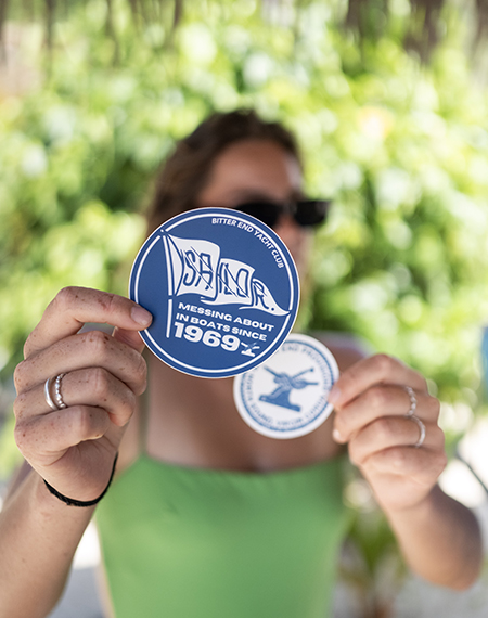 a woman holding up a blue and white circle
