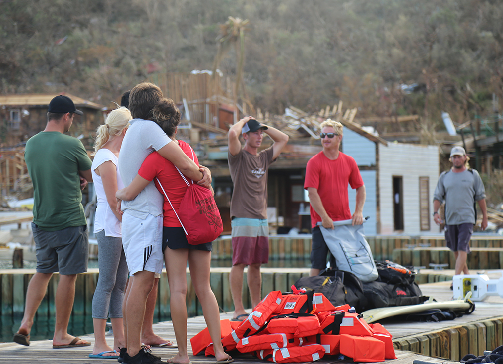 a group of people standing on a dock with life jackets