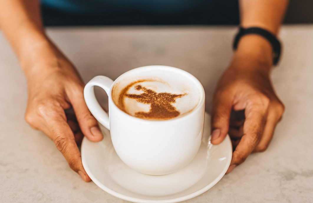 a person holding a cup of coffee
