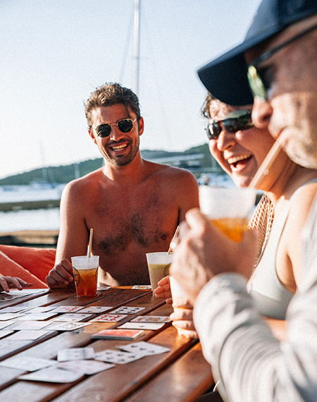 a group of people sitting at a table with cards
