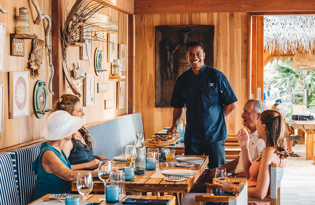 a man serving food to a group of people