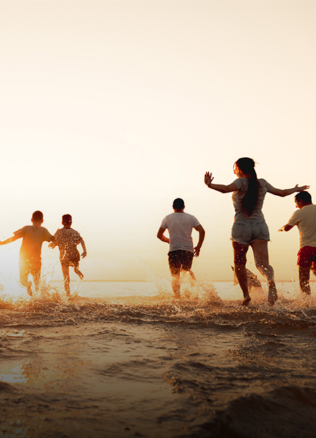 a group of people running in water