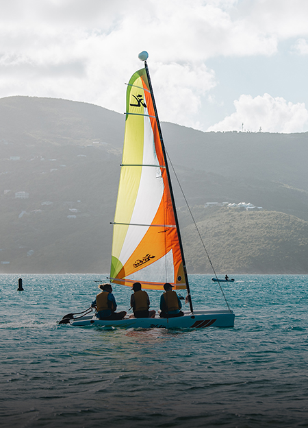 a group of people on a sailboat in the water