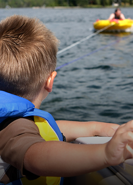 a child in a life jacket on a boat