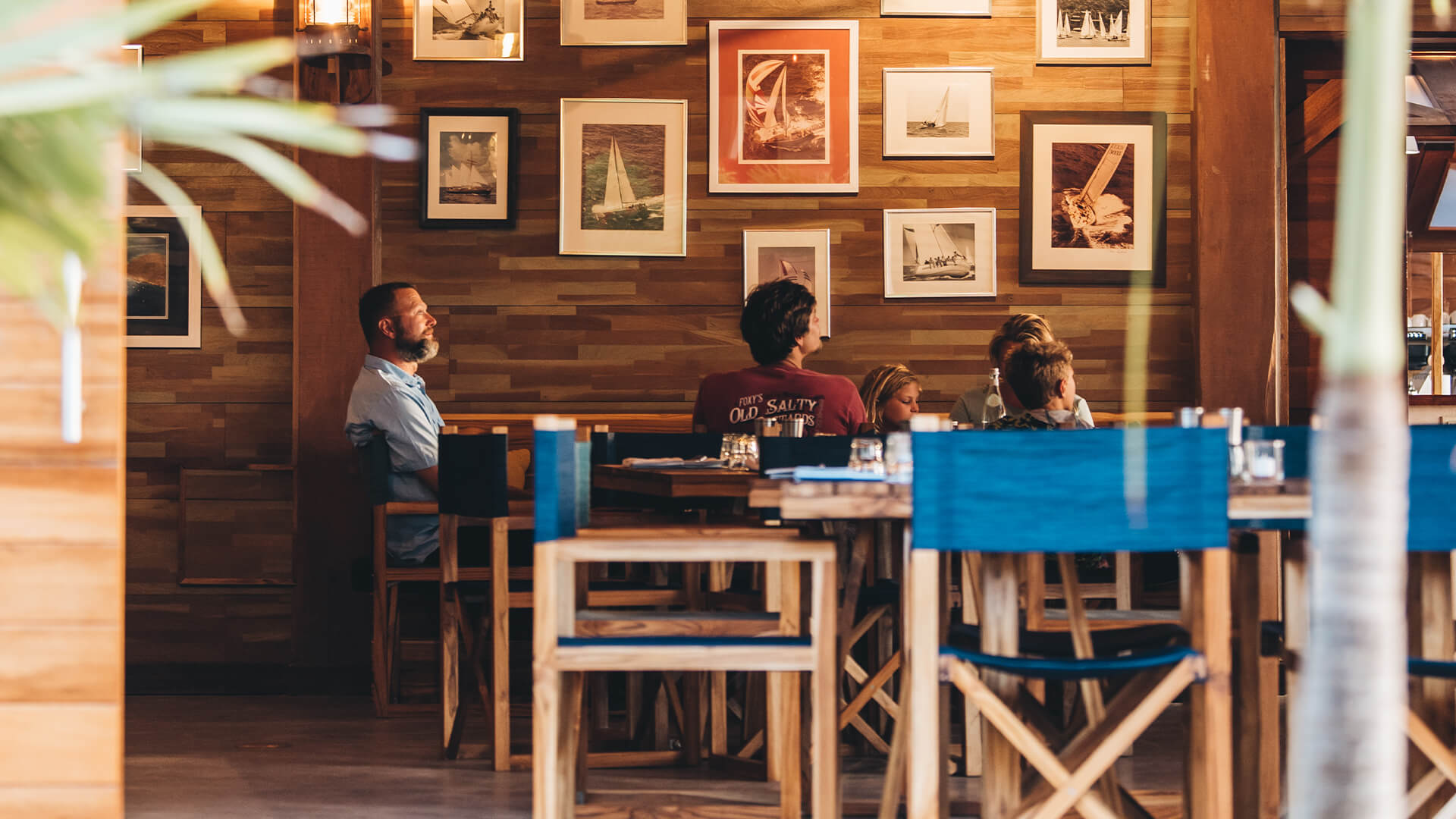 a group of people sitting at tables in a restaurant