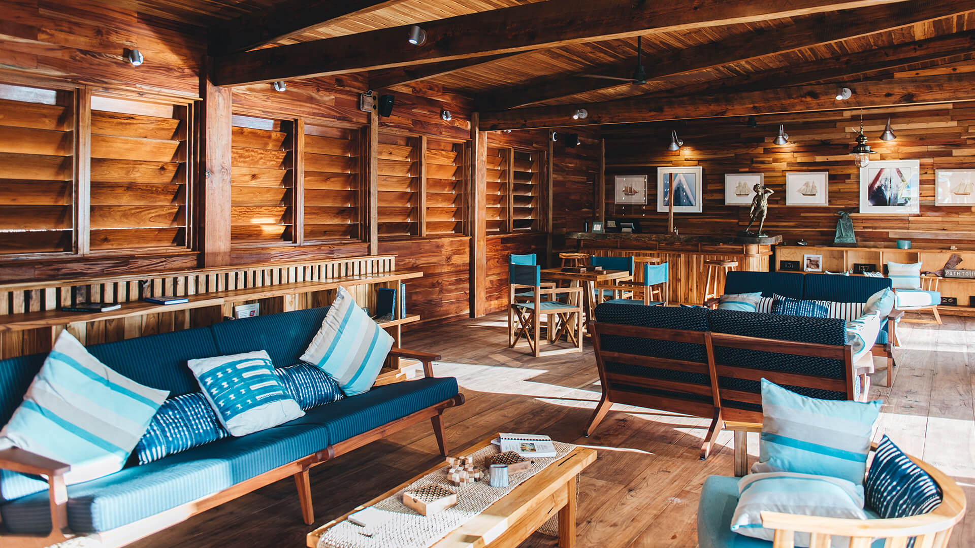a room with wood walls and a couch and tables