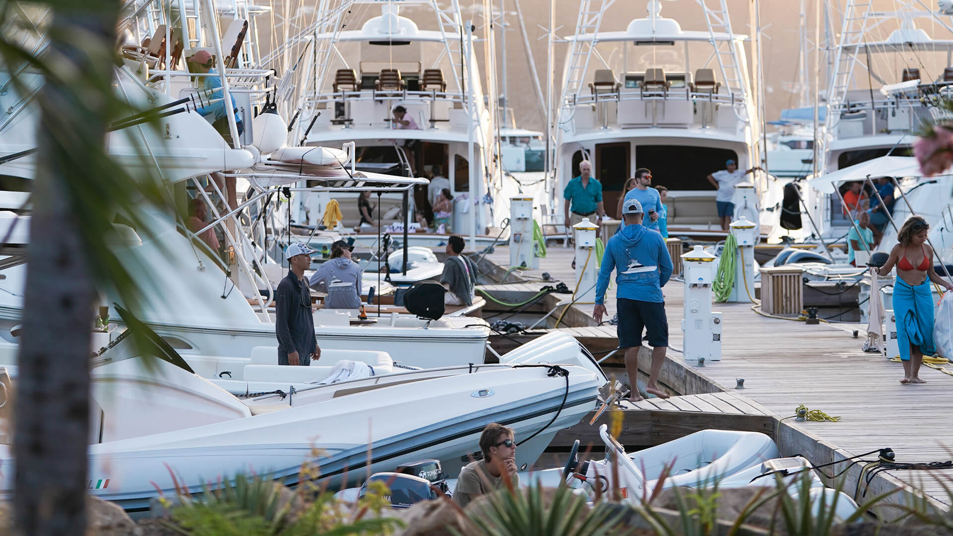 a group of people standing on a dock with boats