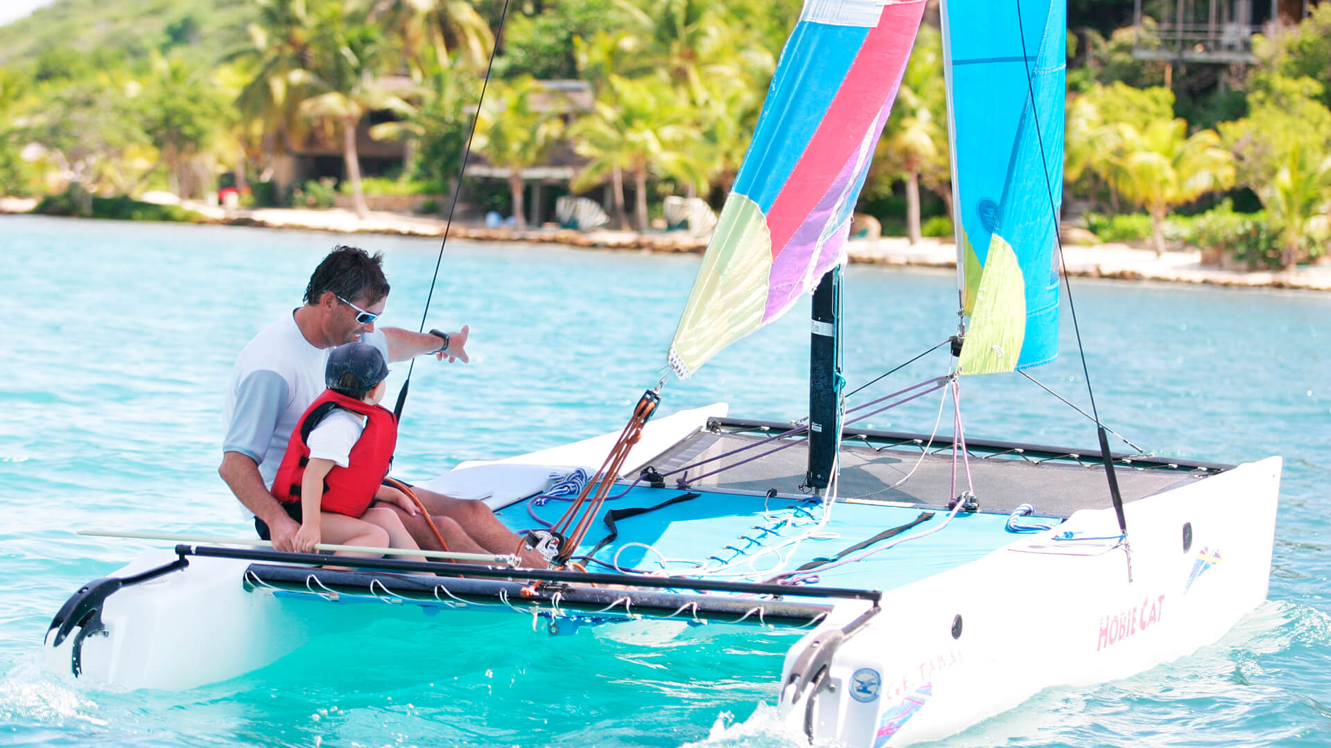 a man and child on a sailboat