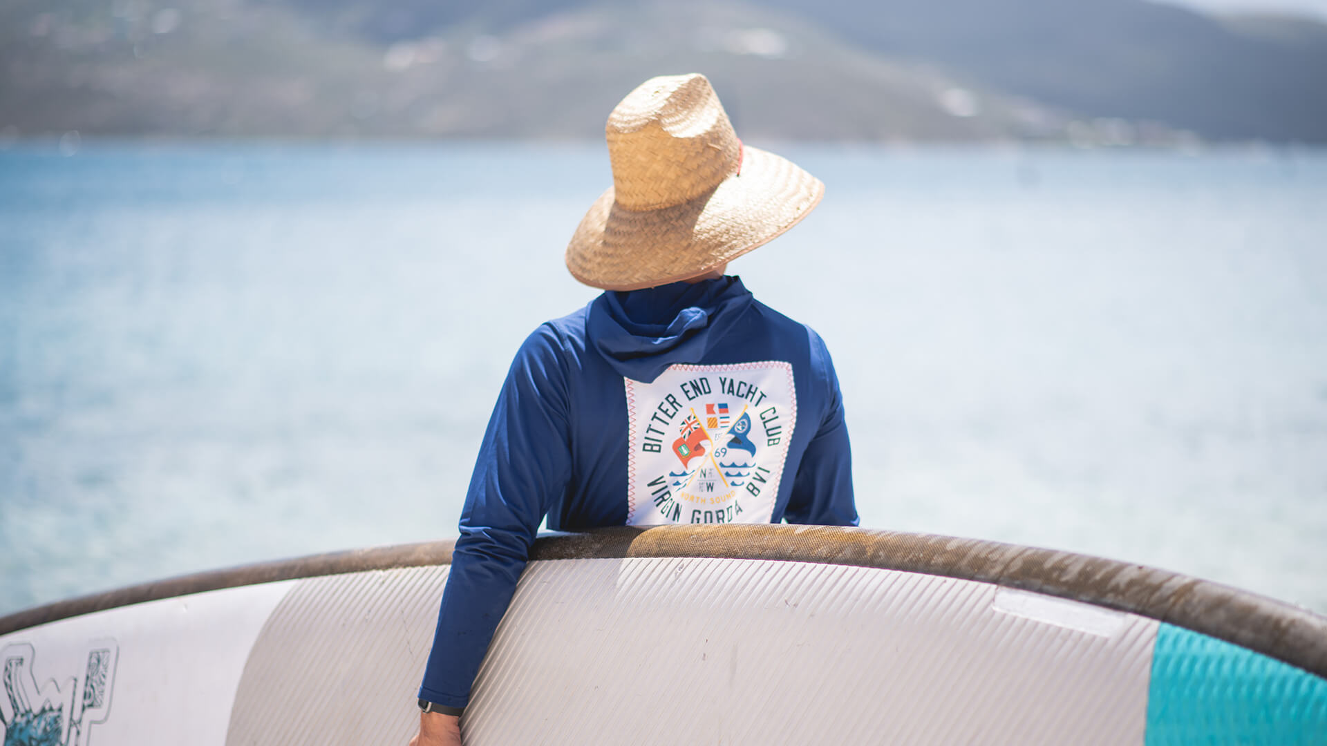 a person wearing a hat and a blue shirt