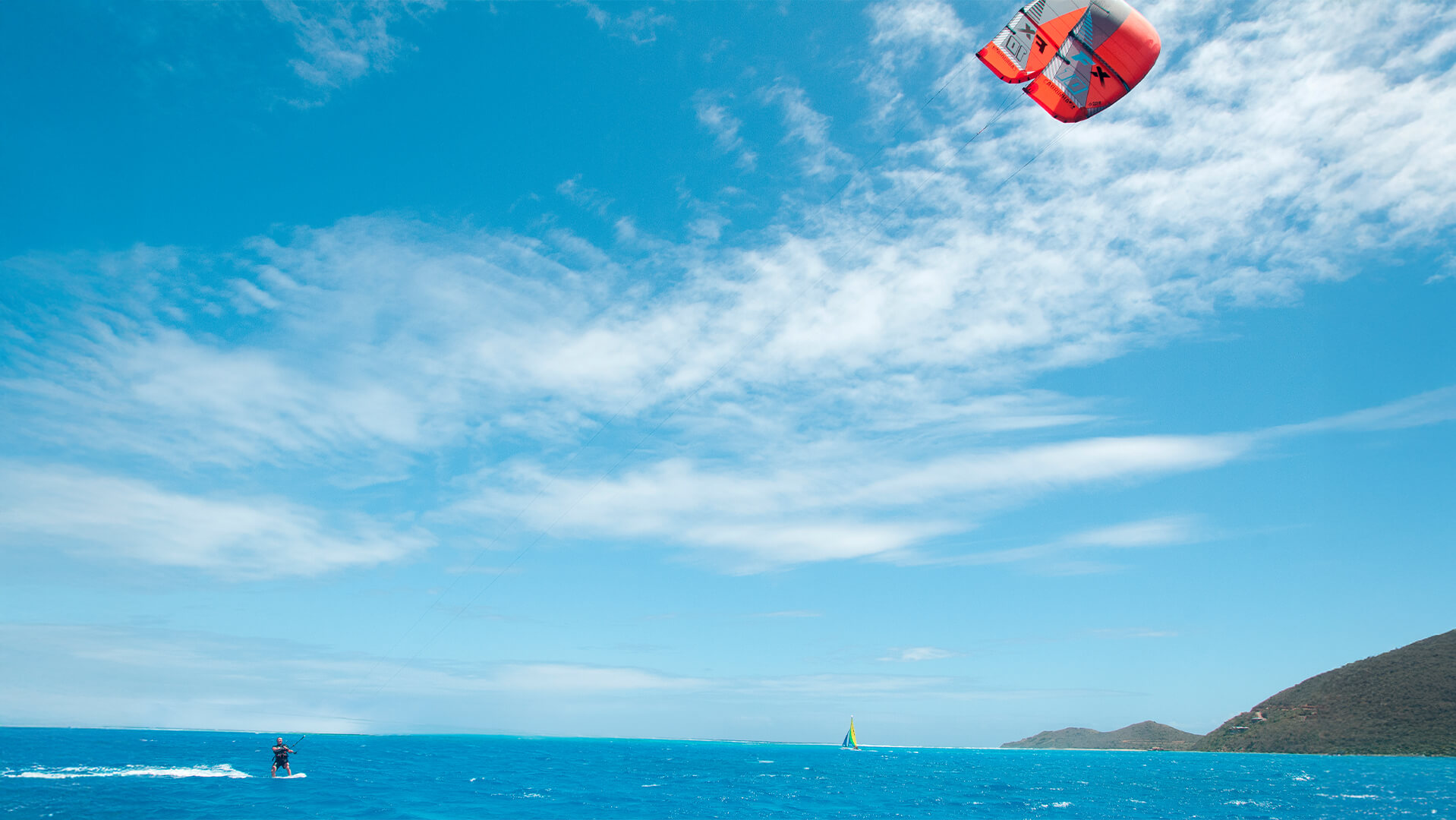 a kite in the air over the ocean