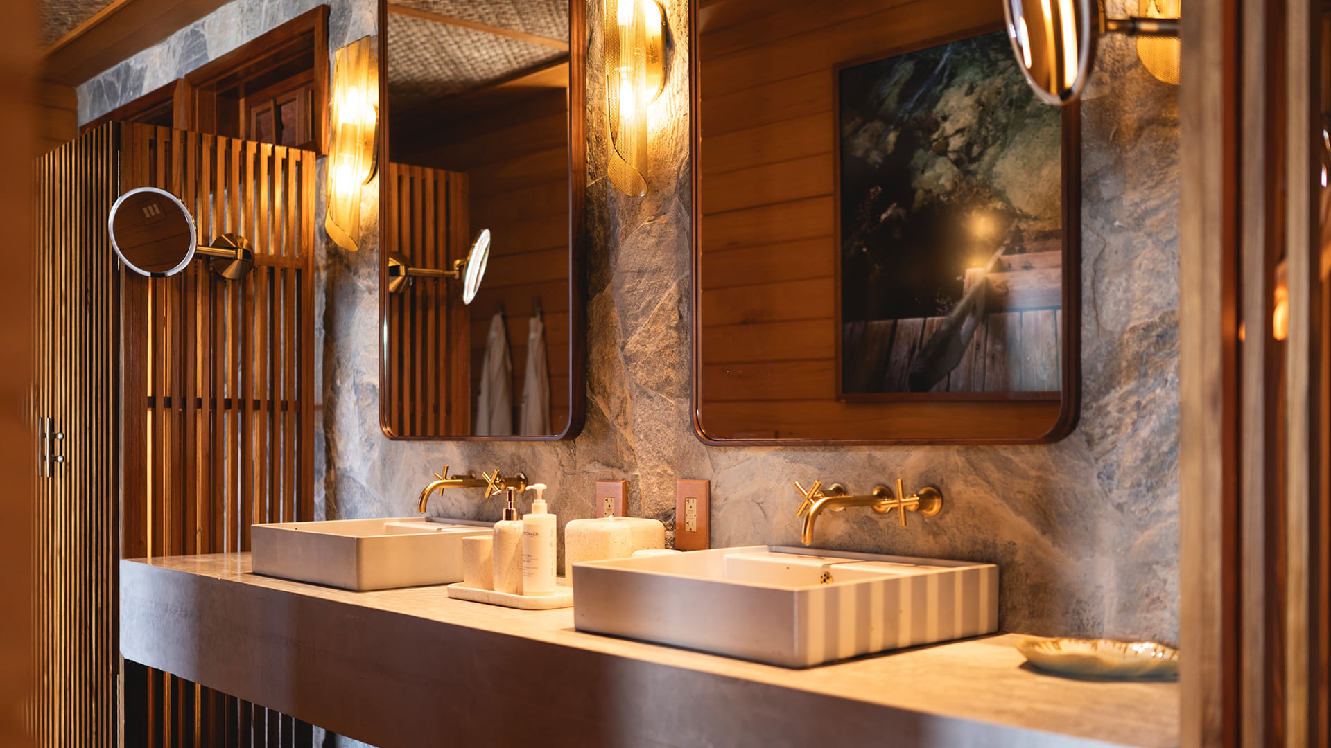 a bathroom with sinks and mirrors