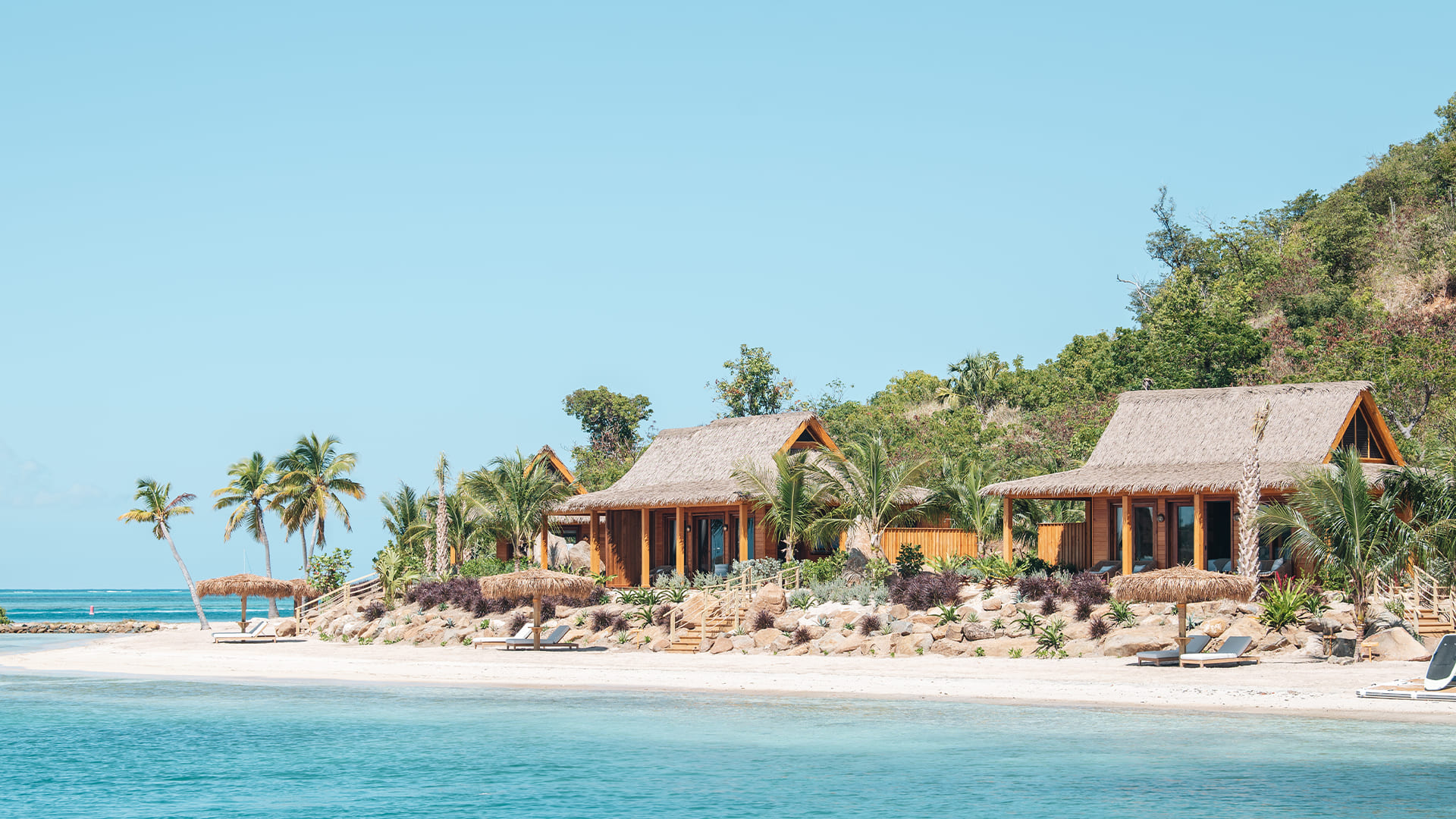 a beach with houses and trees