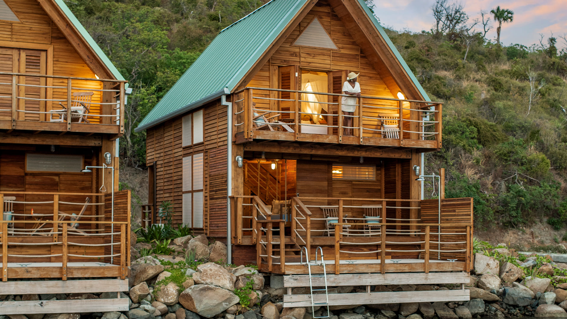 a house with a person standing on the balcony