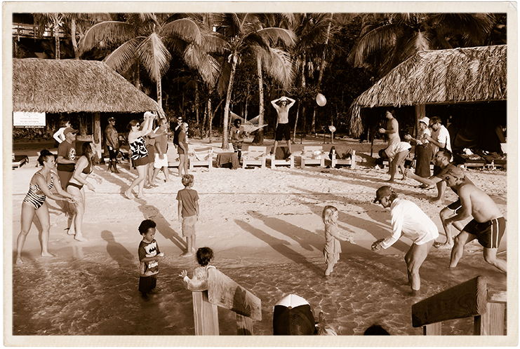 a group of people playing volleyball in a pool