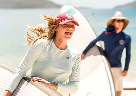 a group of women with surfboards
