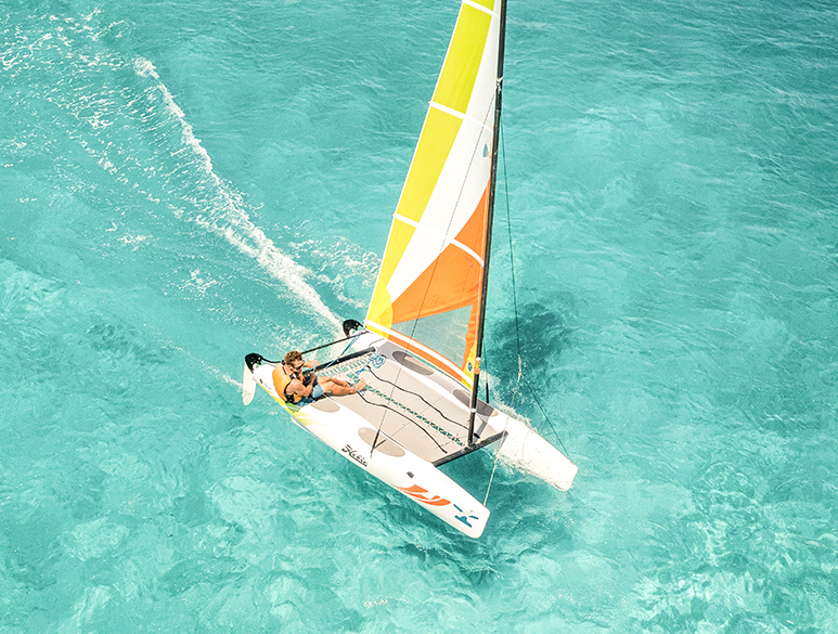 a person on a sailboat in the water