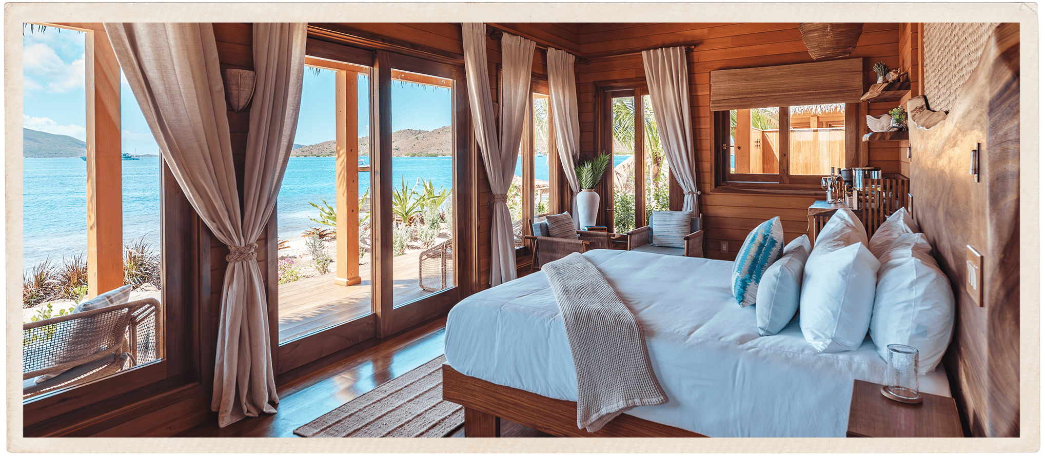 a room with a bed and a view of the ocean
