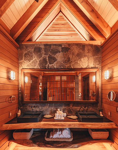 a person sitting on a bench in a bathroom