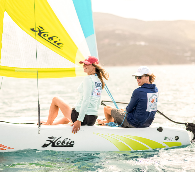 a couple of people on a sailboat