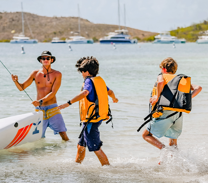 a group of people walking in the water