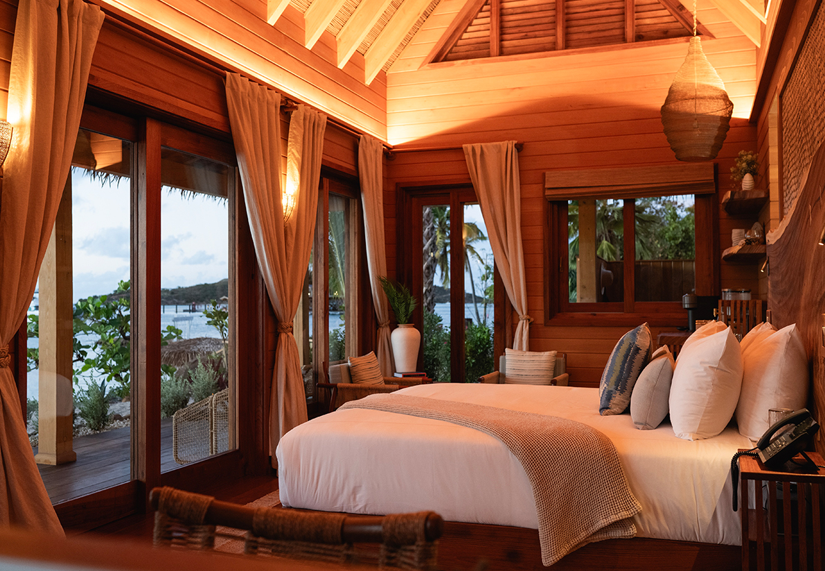 a room with a bed and windows