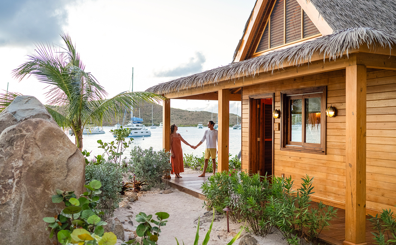 a man and woman holding hands in front of a house