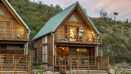a wooden house with a green roof