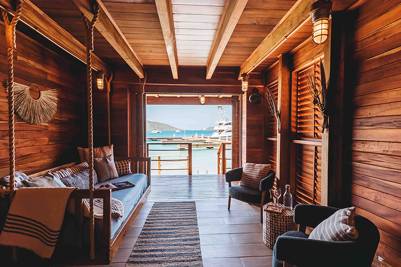 a room with a swing and a boat in the water