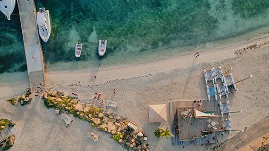 a beach with boats and a body of water