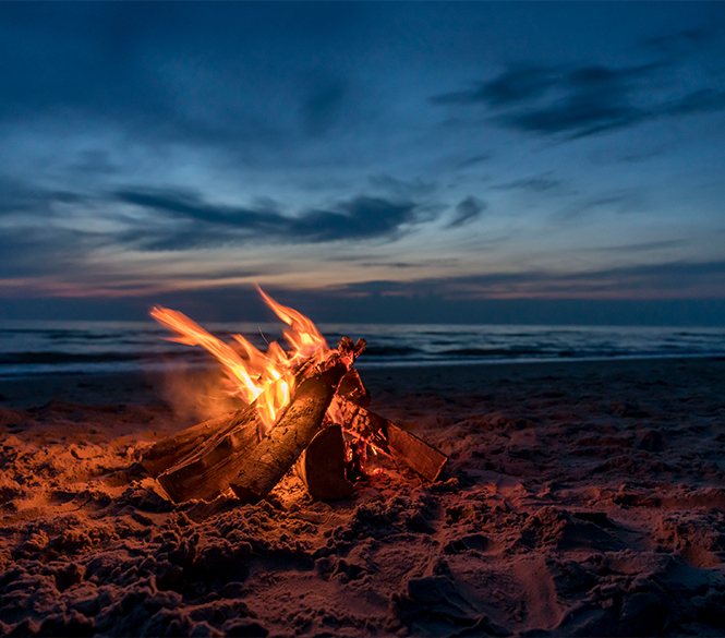 a campfire on a beach