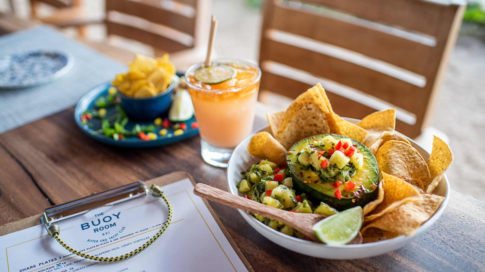 a bowl of food and a drink on a table