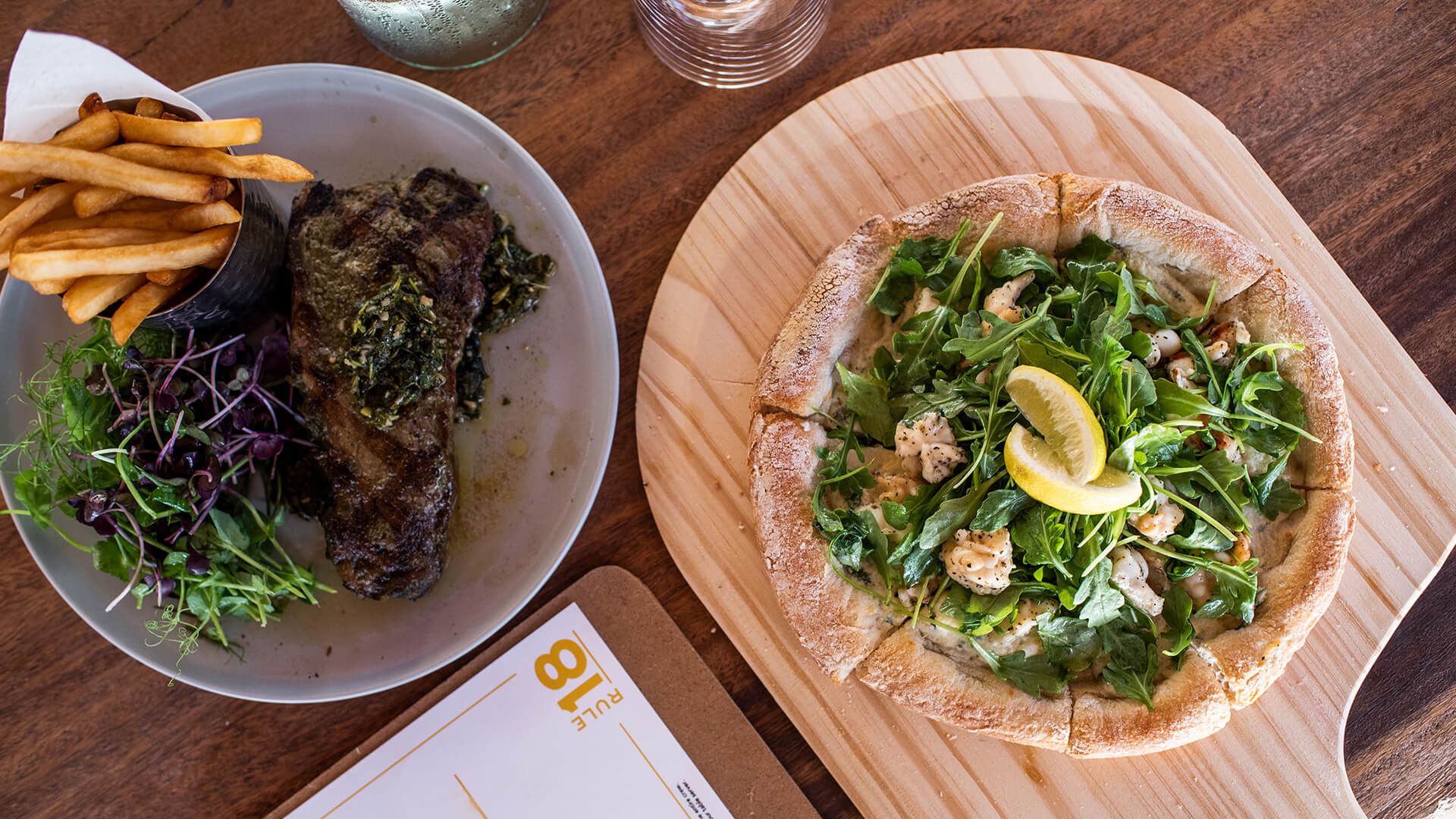 a pizza and steak on a plate