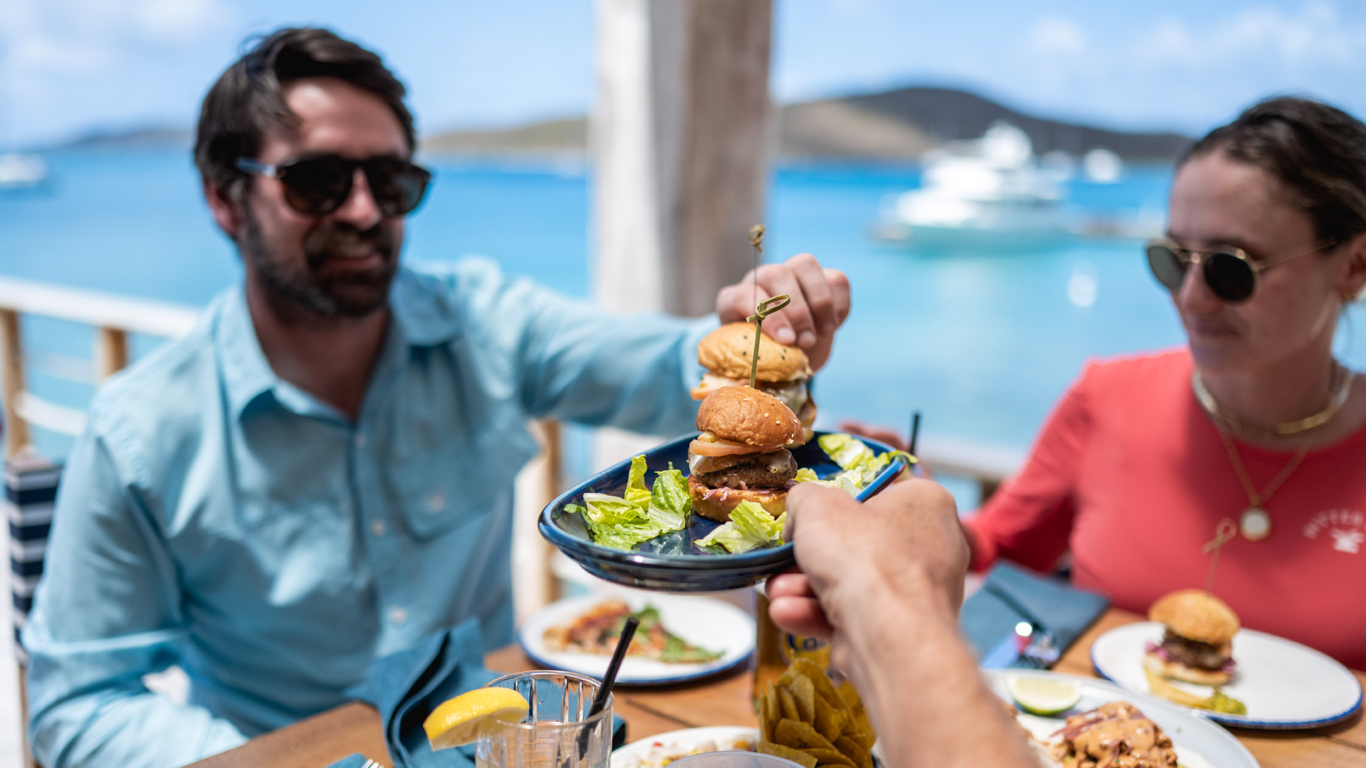 a man handing a plate of food to a man